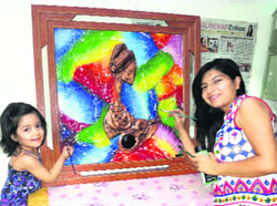 An artist gives the finishing touches to a painting in Jalandhar.