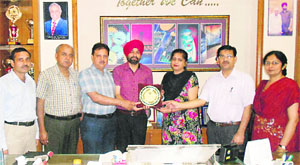 Principal of Mehr Chand Polytechnic College Jagroop Singh honours superintendent examiner Usha Kiran Chawla in Jalandhar on Friday