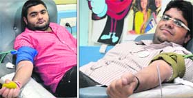 Karan Khurana (left) and Mayank Kapoor donate blood on World Blood Donor Day in Ludhiana on Friday