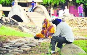 Parents wait for their children outside an examination centre at the PAU in Ludhiana on Friday