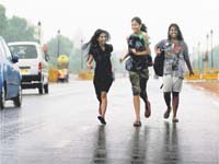 Welcome showers: Girls enjoy rain at the Rajpath in New Delhi on Friday