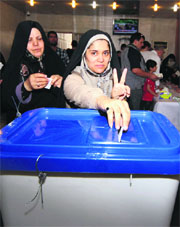 A woman casts her ballot in Kerbala on Friday.