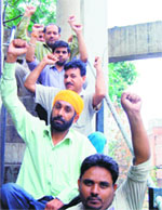 Unemployed youth protest atop a water tank at Pink Plaza in Amritsar on Saturday. Photo: Sameer Sehgal