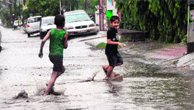 Children enjoy pre-monsoon showers in Karnal on Saturday.