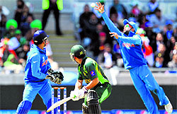 Virat Kohli takes a catch of Kamran Akmal during the Champions Trophy match in Birmingham on Saturday