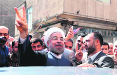 Hassan Rowhani (C) flashes the sign of victory in Tehran. AFP