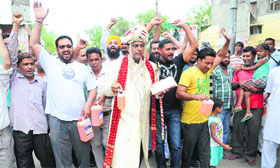 Former municipal councillor Vijay Kumar, attired as a bridegroom, along with residents of Paras Ram Nagar protests against yet another hike in fuel prices in Bathinda on Sunday.