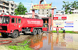 A fire tender being used to pump out rainwater from the premises of the mandir