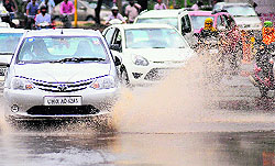  3. Vehicles wade through a waterlogged road near the Housing Board light point in Manimajra on Sunday. Tribune photos: parvesh chauhan