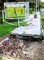 The road gully in Sector 5, Chandigarh, blocked with dry leaves; and (below) A flooded road gully at Sector 17 in Chandigarh on Sunday