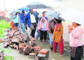 District Magistrate BVRC Purushottam inspects a rain-hit locality in Dehradun on Sunday