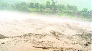 A river in spate following heavy rain in Uttarakhand on Sunday.