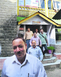 A CID team takes away documents after a raid at a hotel in Mandi on Sunday. 
