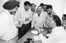Transport Minister GS Bali listens to grievances of people at Nagrota Bagwan on Saturday. 