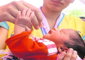 An infant being administered polio drops during the pulse polio drive in Jalandhar on Sunday