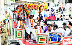 Devotees participate in a religious procession to mark the 615th birth anniversary of saint Kabir in Jammu on Sunday