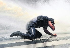 A protester braves water cannon during a demonstration at Kizilay square in central Ankara on Sunday.