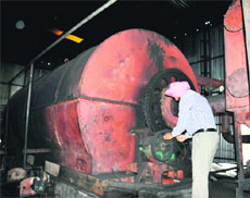An official of the Punjab Pollution Control Board seals a waste tyre recycling factory, which was burnt on the intervening night of June 15 and 16, in Amritsar.