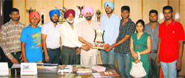 Staff and students of Khalsa College, Amritsar, with the winning trophy in Amritsar on Monday.