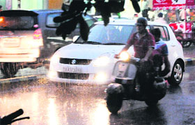  Residents had to switch on the headlights of their vehicles as it got dark before sunset due to the clouds and rain in Amritsar on Monday. 