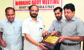 Members of the Income Tax Employees Federation felicitate the chief guest at a meeting of the executive body held in the city on Monday.