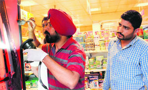 CFSL experts collect samples from the shop inside the petrol pump at Sector 4 where the theft took place. 