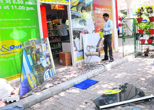 A glass door lies broken at a shop inside a petrol pump in Sector 4 where the theft took place. 