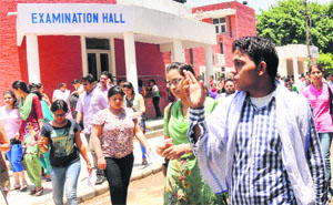 Students come out after appearing for the CET at Panjab University in Chandigarh on Monday. 
