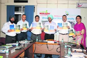 A souvenir being released on World Day to Combat Desertification at a function held at the Forest Research Institute in Dehradun on Monday