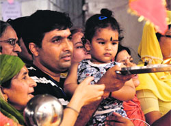 Devotees offer prayers at Mata Kheer Bhawani temple in Jammu on Monday. 