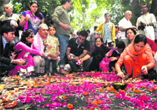 Devotees light lamps at Kheer Bhawani temple at Tulamulla near Srinagar on Monday. 