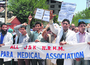 Members of the J&K Paramedical Employees Association shout slogans in support of their demands in Srinagar on Monday. 