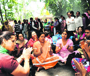 A goup of women devotees sing religious songs at the Kheer Bhawani temple at Tullmulla in Ganderbal district on Monday.