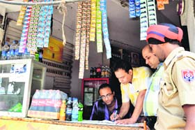 Officials issue a challan to a shopkeeper in Ludhiana