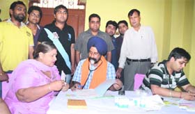 A doctor examines a patient during a free medical check-up camp at Aggarsen Dharamshala, Shakti Vihar, Ludhiana