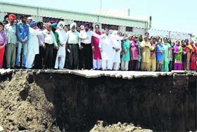 Residents point towards the wall that caved in at Khanna on Monday