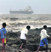 Youngsters visit the spot where merchant navy ship Pratibha Tapi is stuck off Mumbai on Monday.