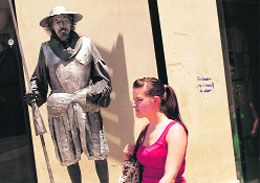 A street artiste (L) dressed as Cervantes Don Quixote performs at Malaga in Spain on Monday. 