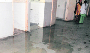 A washroom in the emergency ward of Guru Nanak Dev Hospital gets flooded due to the choking of the sewerage system in Amritsar on Tuesday. 