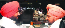 MP Ravneet Bittu (left) and DC Tajinderpal Singh Sidhu during a district-level meeting of the Vigilance and Monitoring Committee at the Municipal Corporation Bhawan in Mohali on Tuesday. 