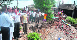 Chief Minister Vijay Bahuguna inspects a flood-hit area in Dehradun on Tuesday.