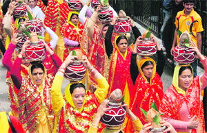 Devotees hold kalash during a procession in Shimla on Monday. 
