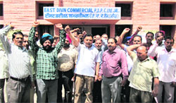 Members of PSEB Employees Joint Forum stage a protest in front of the PSPCL office in Jalandhar on Tuesday. Tribune Photo: Malkiat Singh