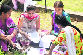 Students fill admission forms at the Government College for Women in Jammu on Tuesday.