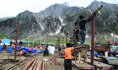 Temporary sheds are being set up at the Baltal base camp, some 115-km from Srinagar, on Tuesday as preparations start for the Amarnath yatra scheduled to commence from June 28.