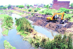 A JCB machine being used to clear the Chhoti Canal in Patiala on Tuesday. Tribune photo: Rajesh Sachar