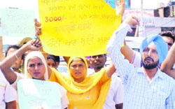 Members of the Rural Health Pharmacists Action Committee protest in Patiala on Tuesday. Tribune photo: Rajesh Sachar