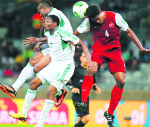 Tahiti's Teheivarii Ludivion (R) jumps for the ball with Nigeria's Ahmed Musa (7) and Brown Ideye during their Confederations Cup Group B match at the Estadio Mineirao in Belo Horizonte.