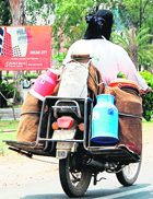 A milkman supplies milk in Amritsar.