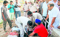 Police officials with the bodies of the deceased